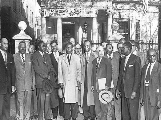 Brothers of Upsilon Sigma gathered on the steps of the Sigma House