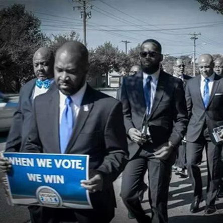 Brothers marching with a sign reading When We Vote, We Win